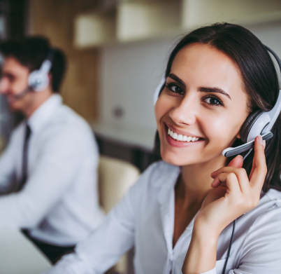 How can I help you? Beautiful call center workers in headphones are working at modern office.